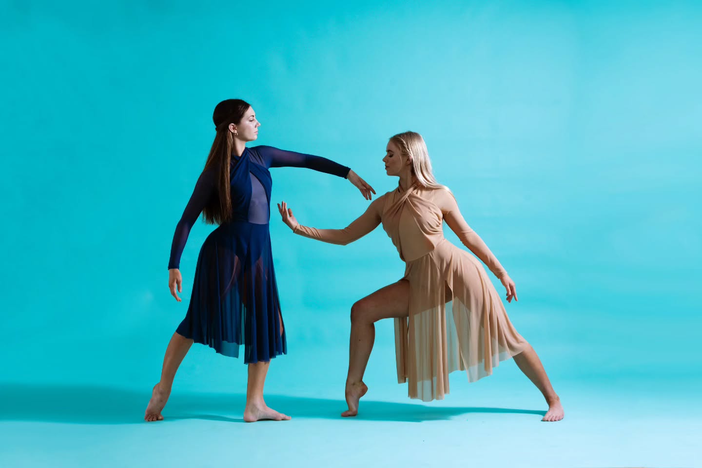 Two Australian Youth Arts Productions dancers posing together in a studio.
