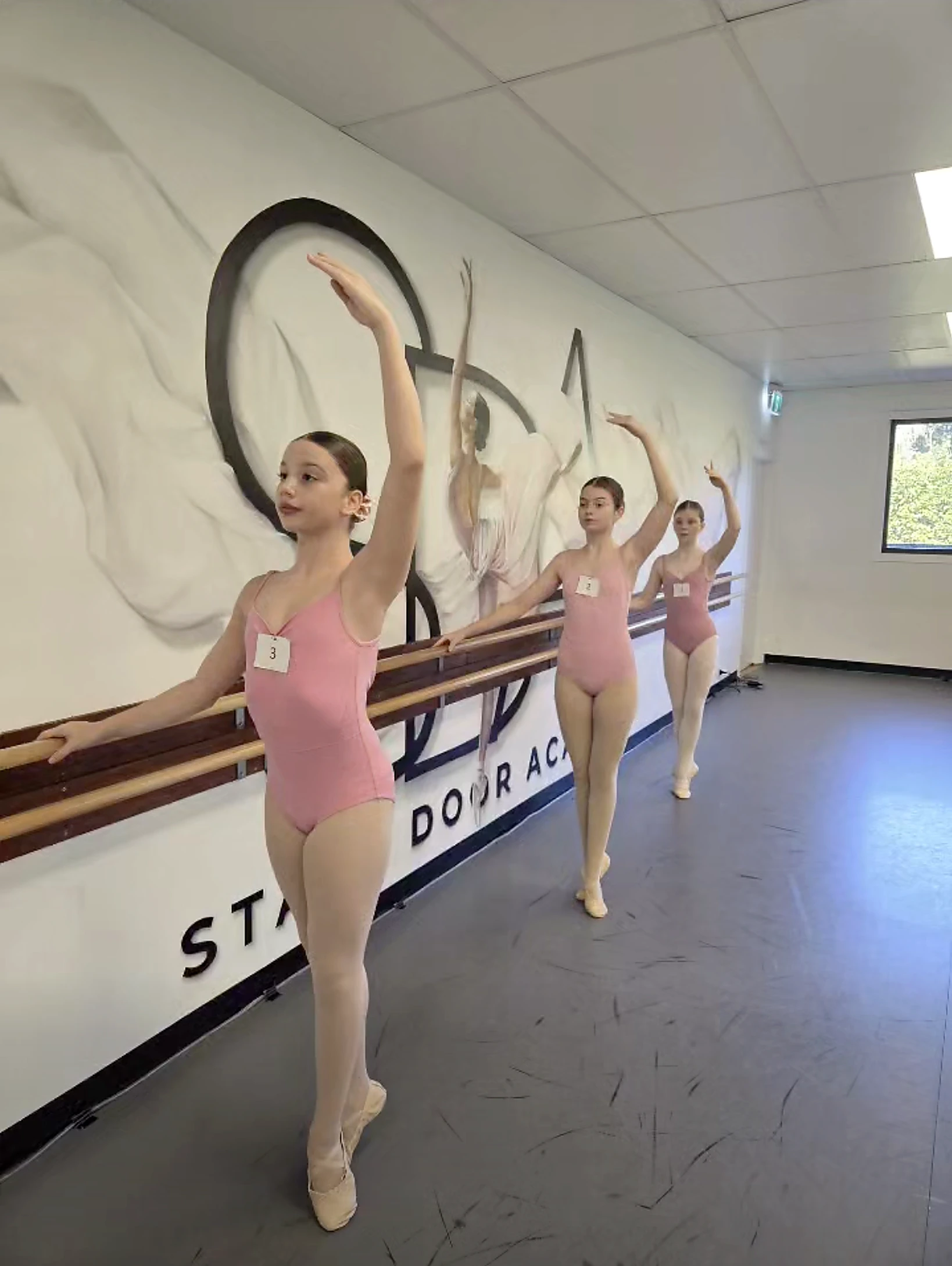 Stage Door Academy ballet students training at the studio barre