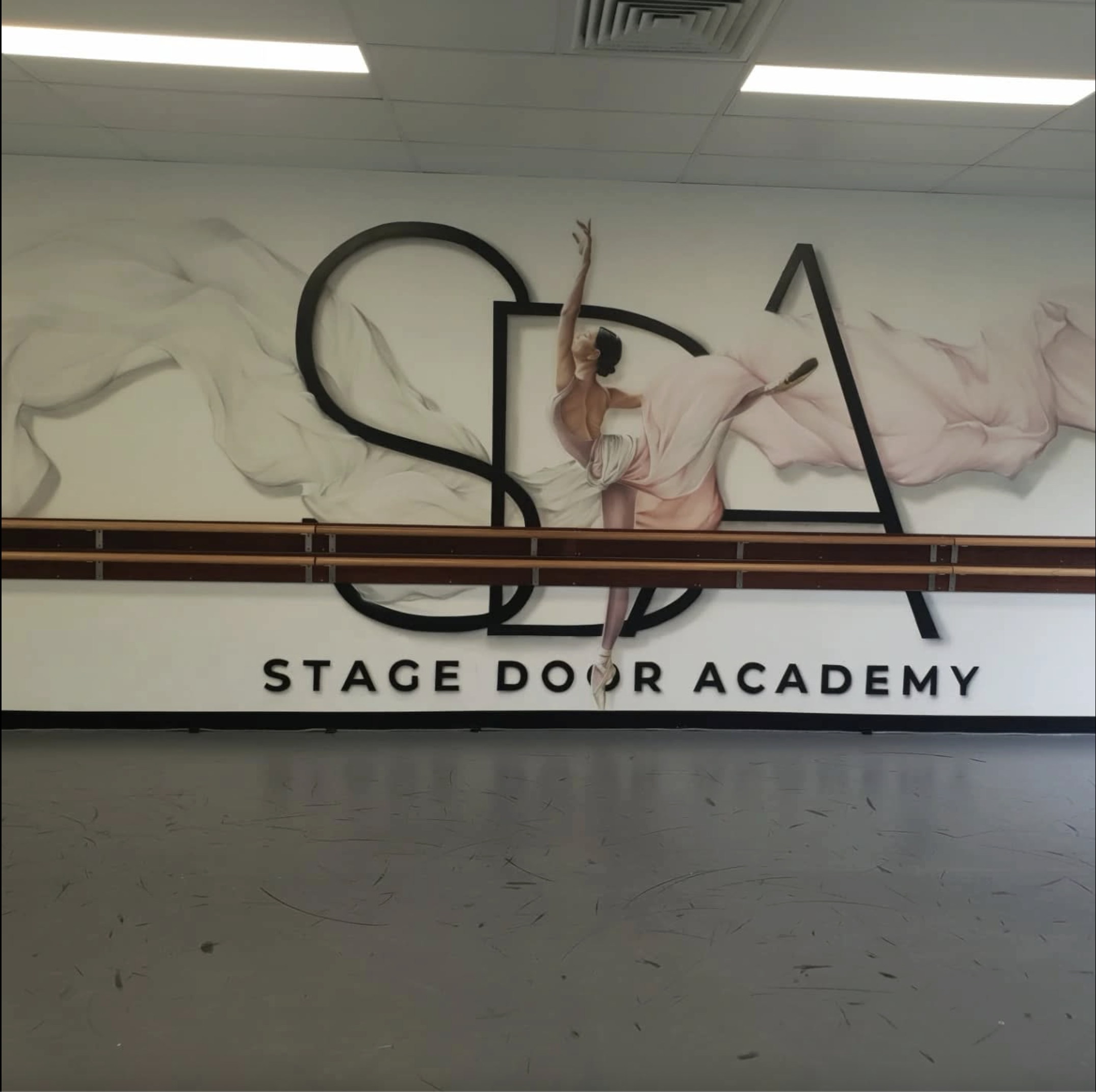 Stage Door Academy studio wall and dance training space.