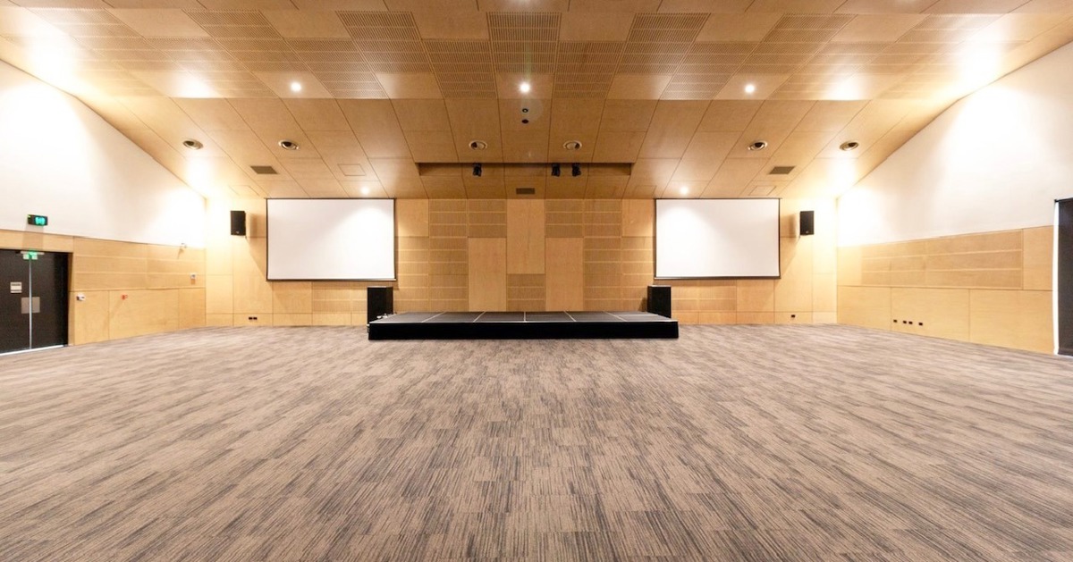 The Well hall in Upper Coomera shown empty, with open floor space and a low stage